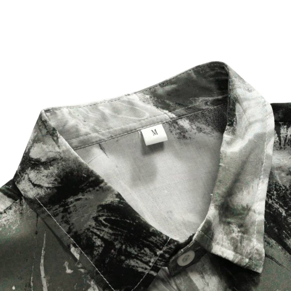 Detalhe da gola da Camisa Vinser Brisa Costeira, destacando o acabamento do colarinho e a estampa abstrata em tons de preto, cinza e branco.