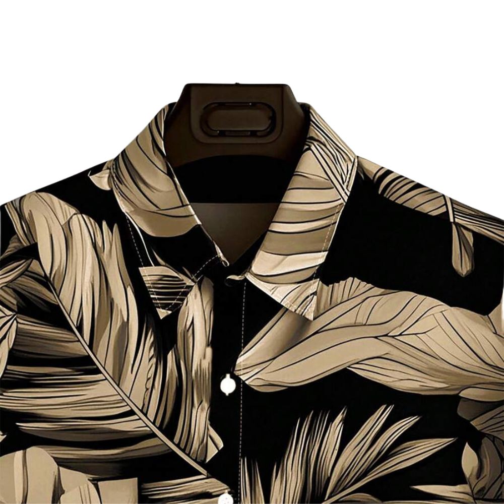 Detalhe da gola da Camisa Vinser Costa Dourada, destacando o acabamento refinado, a padronagem de folhas em tons dourados e o tecido de toque leve.