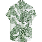 Vista traseira da Camisa Vinser Costa Verde com estampa tropical de folhas verdes sobre fundo branco, destacando o caimento leve e o design elegante.
