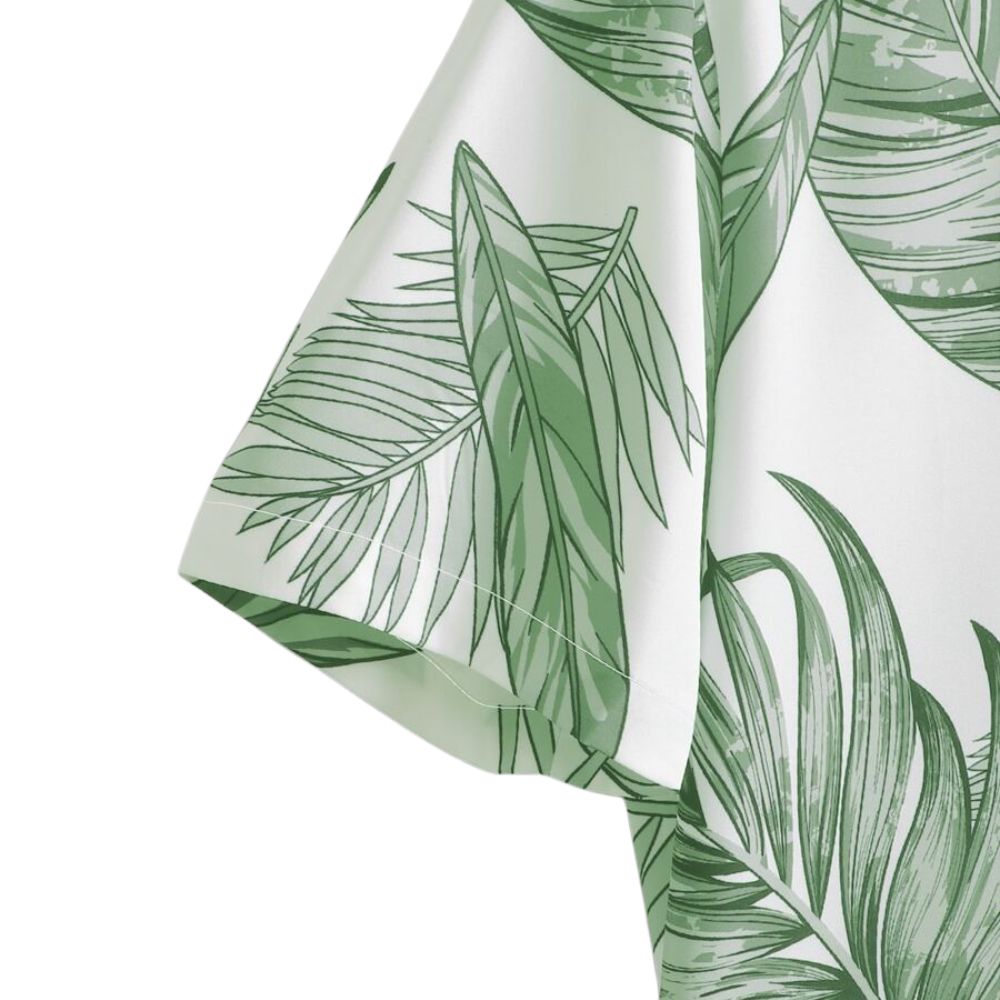 Detalhe da manga da Camisa Vinser Costa Verde, destacando a costura precisa, acabamento refinado e estampa tropical de folhas verdes.
