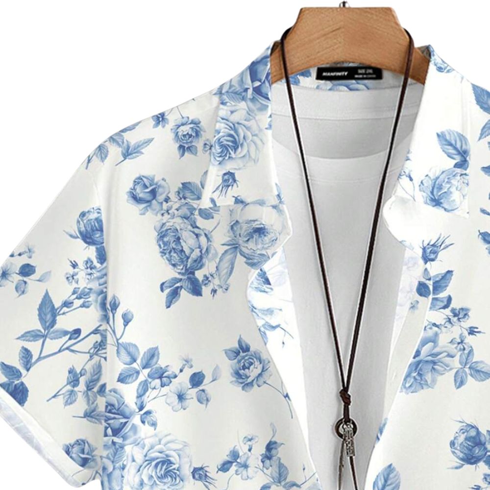 Detalhe da gola da camisa masculina Vinser branca com estampa floral azul, destacando o acabamento da gola, a abertura frontal e o padrão floral sofisticado.