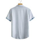 Costas da camisa masculina Vinser Iracema branca com detalhes em azul nas mangas, manga curta e acabamento premium