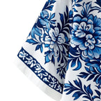 Detalhe da manga da camisa masculina Vinser Itacaré branca com estampa floral azul e acabamento premium