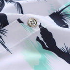 Detalhe do tecido da camisa masculina Vinser Praia do Forte com botão premium, estampa tropical de coqueiros em preto e verde-água sobre fundo branco. Tecido leve, macio, respirável e com acabamento de alta qualidade.